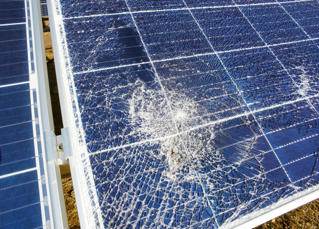 Broken destroyed cracked hole in solar panel